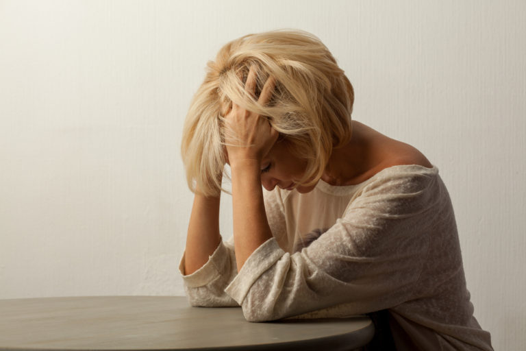 blond w head in hands