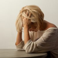 blond w head in hands
